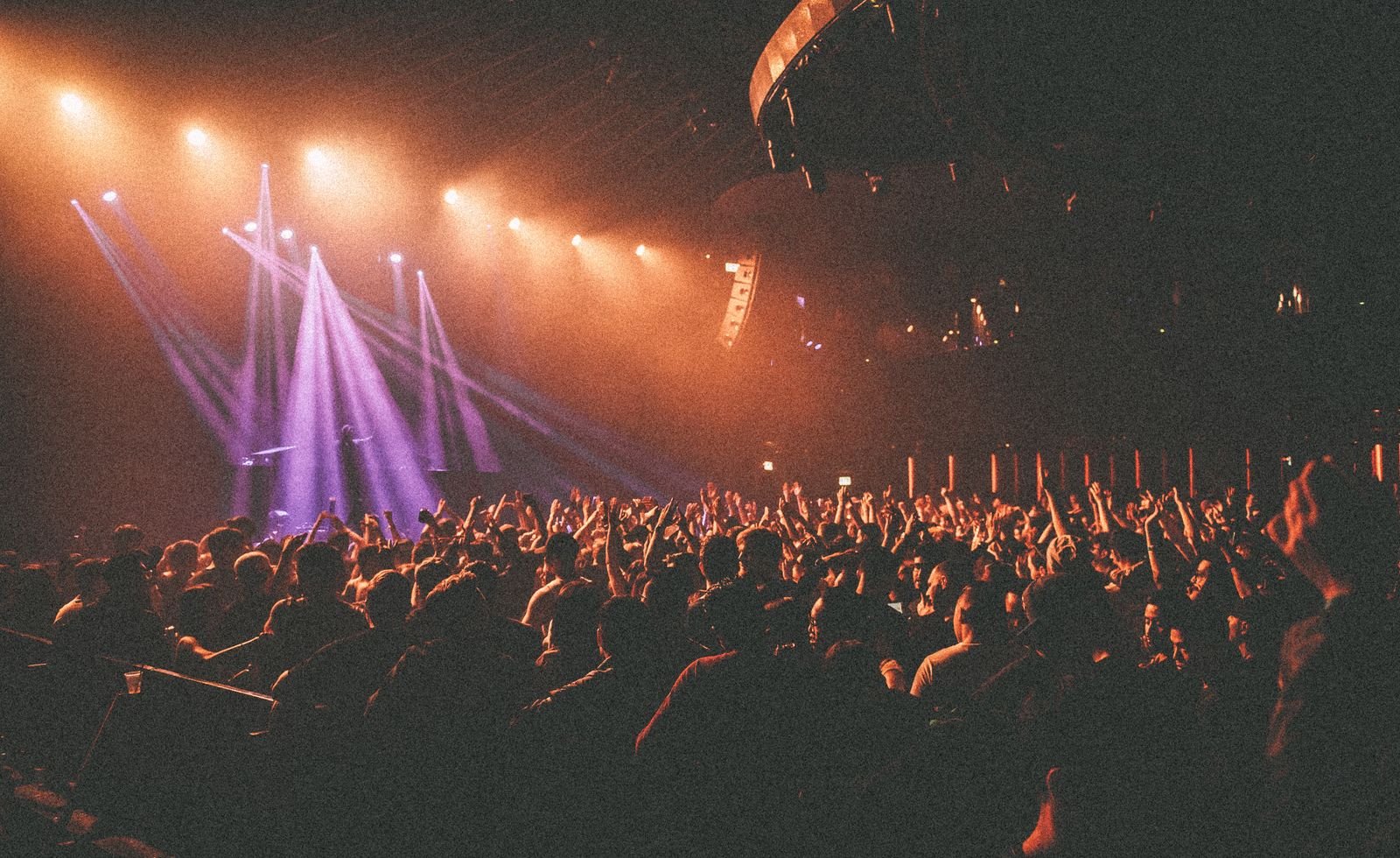 Silhouetted crowd at a packed live rock concert