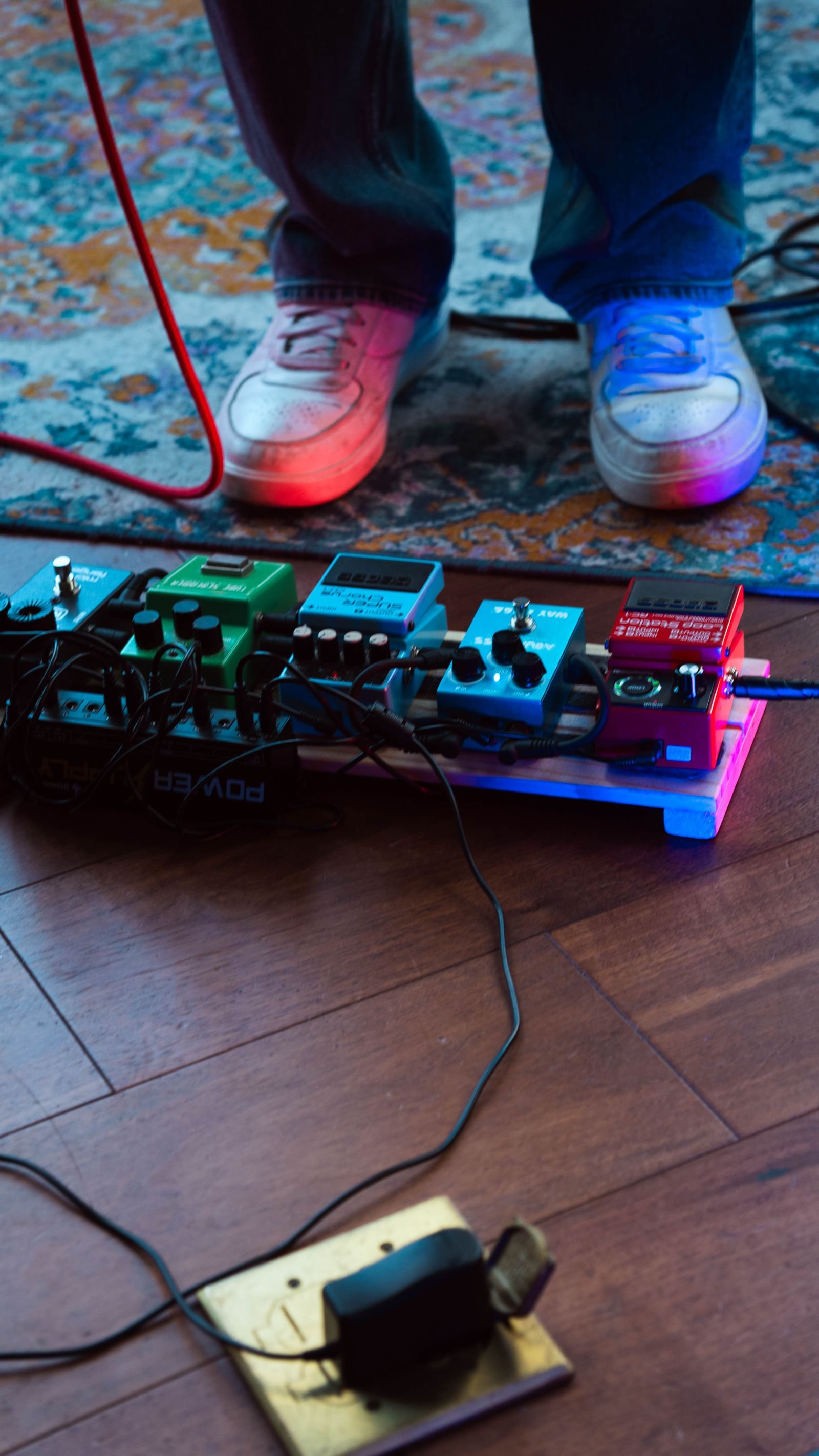 A pedalboard of guitar effects pedals viewed from above