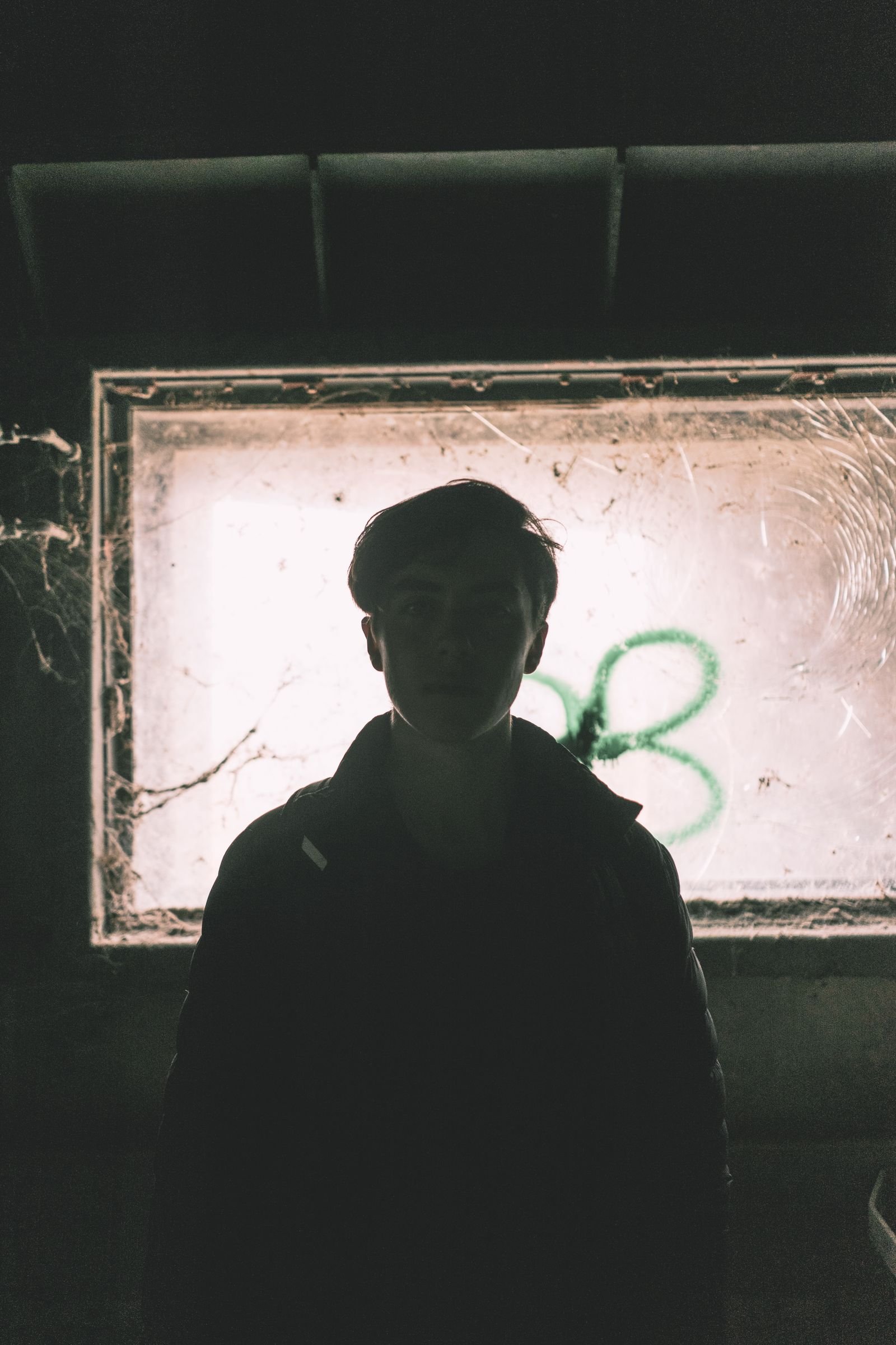 Grunge-styled portrait in layered clothing with a worn, modern feel
