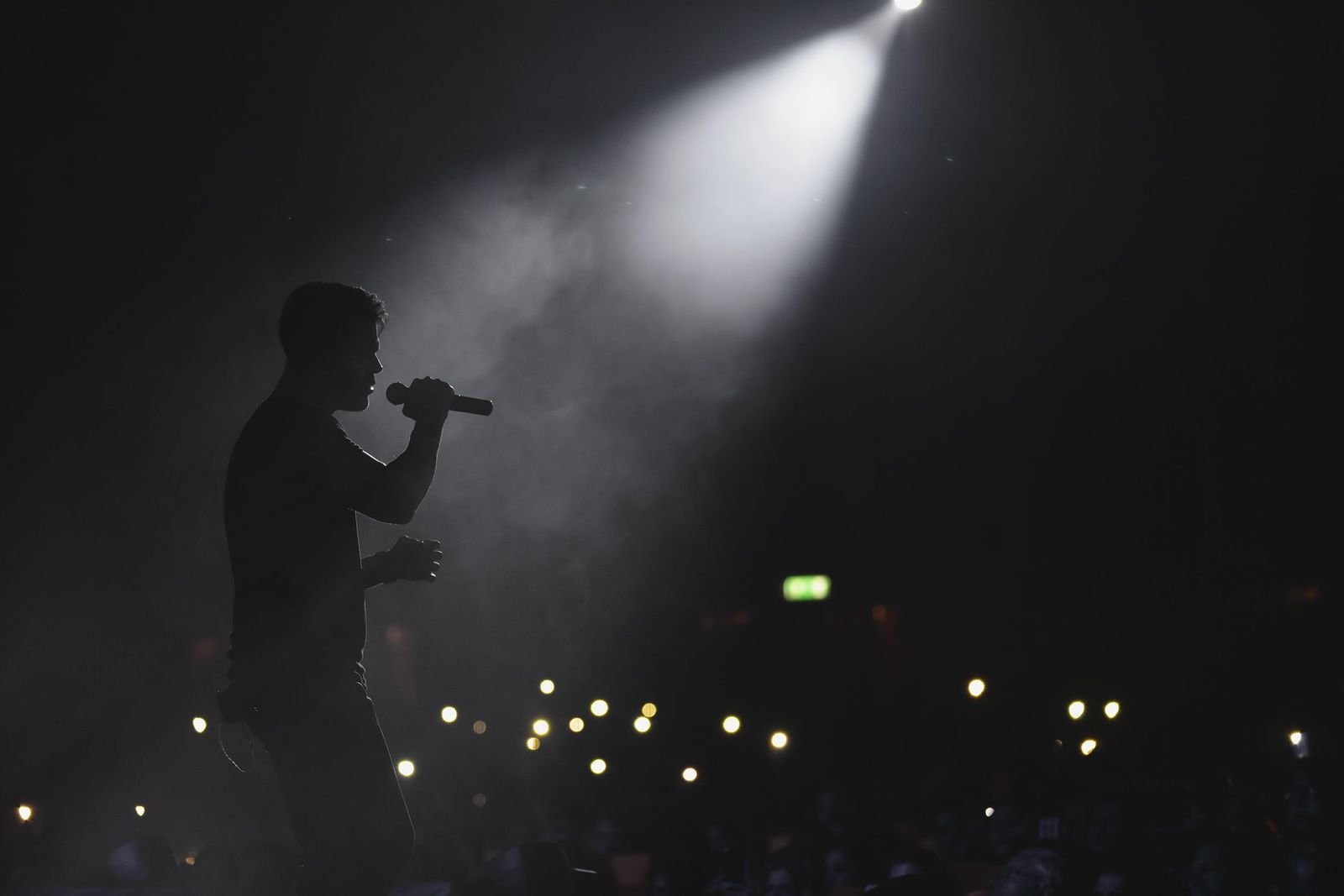 A singer gripping a microphone mid-performance