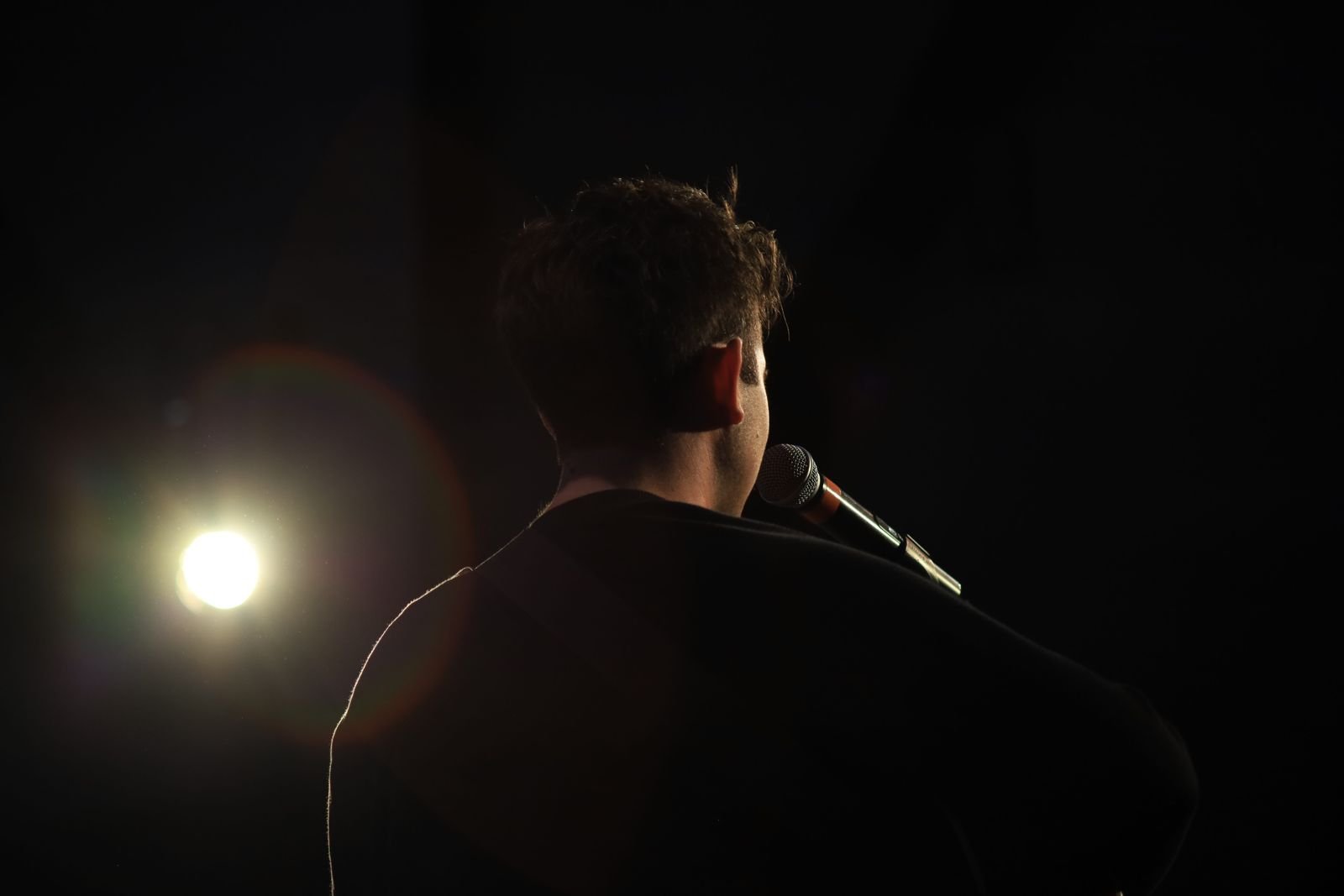 A vocalist performing under stage lights, capturing the raw energy of Nevermind-era Nirvana