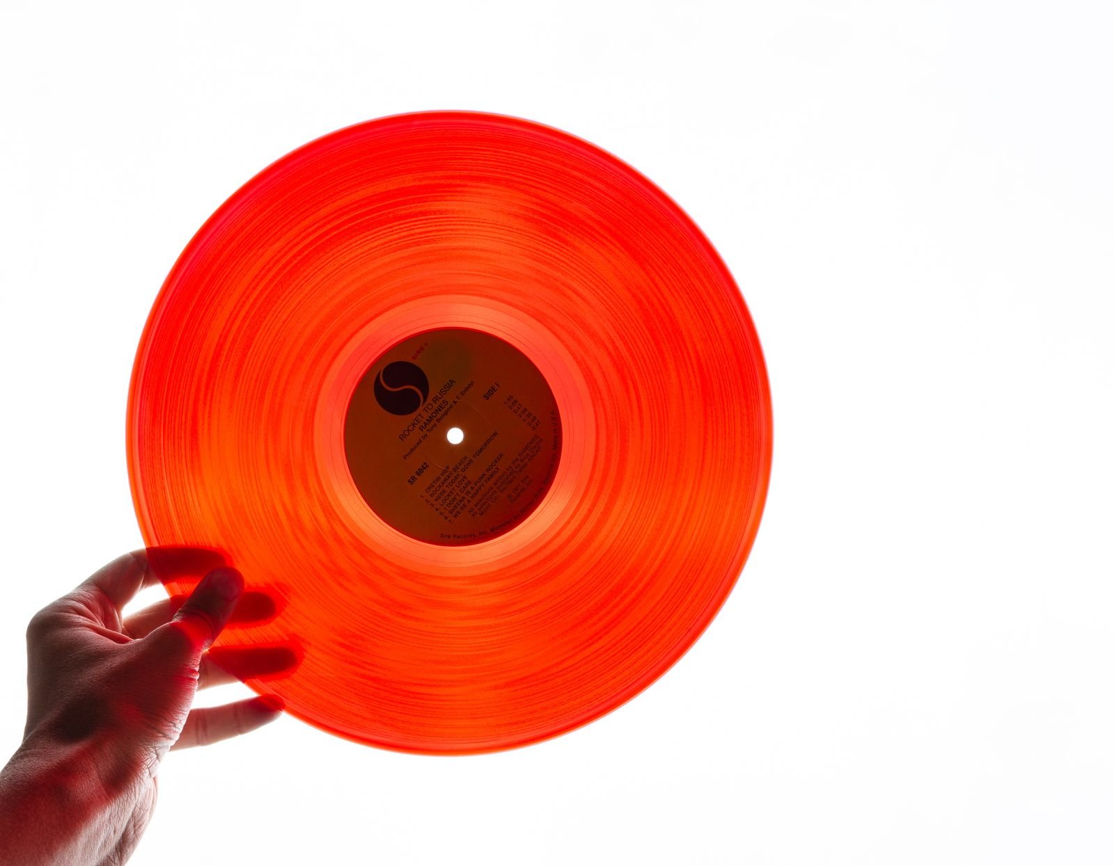 Close-up of a black vinyl record spinning, evoking a classic grunge album collection
